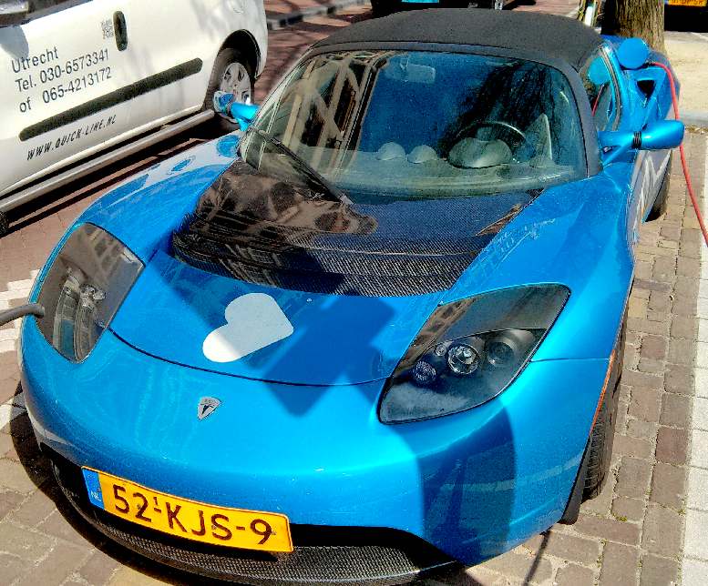 Blue electric car charging in Amsterdam